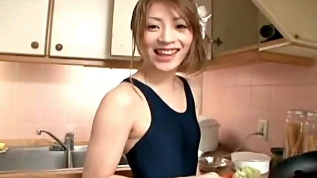 Japanese girl cooks in a swimsuit