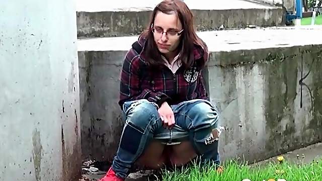 Nerdy girl takes a messy piss outdoors